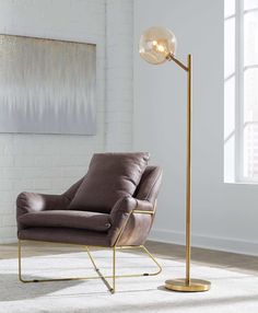 a living room with a chair and a floor lamp