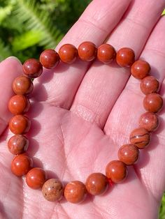 Red Jasper Bracelet Healing Jasper is known as the supreme nurturer because of its abilities for healing the wearer. It grounds, balances, soothes and stabilizes the energy. The stone strengthens one’s spiritual awareness. Jasper is an uplifting gemstone that helps one see the good in others and find harmonious balance. Wear Jasper to enjoy constant spiritual support during your day. Beaded bracelet stretches to 5 inches in diameter. One size fits all. Beads are 8mm. Jasper Bracelets For Healing With Round Beads, Spiritual Jasper Bracelet With 8mm Beads, Spiritual Jasper Bracelets With 8mm Beads, Healing Jasper Bracelets With 8mm Beads, Red Jasper Jewelry, Red Jasper Bracelet, See The Good, Jasper Jewelry, Jasper Ring