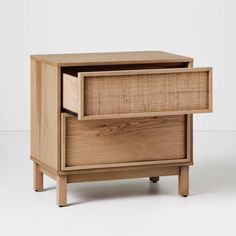 a wooden cabinet with two drawers on one side and an open drawer on the other