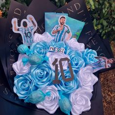 a blue and white bouquet with an image of messi