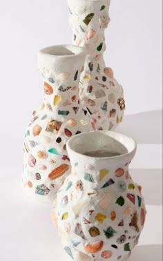 three ceramic vases are stacked on top of each other in different shapes and sizes