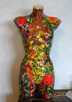 a mannequin is decorated with flowers and leaves