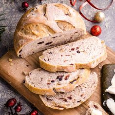 sliced loaf of bread sitting on top of a wooden cutting board next to christmas decorations