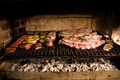 meat and vegetables cooking on an outdoor grill