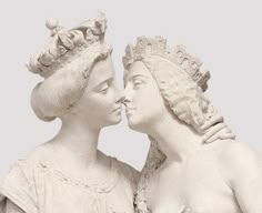 two statues of women are facing each other