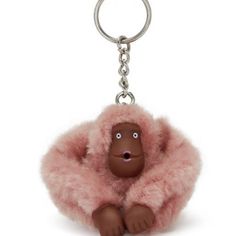 a brown gorilla keychain with pink fur around it's body and eyes