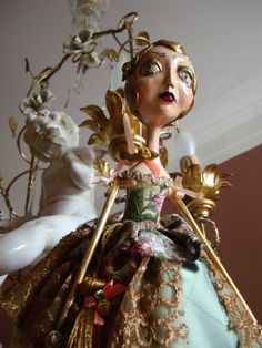 a close up of a figurine wearing a dress