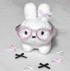 a white stuffed animal with glasses on it's face