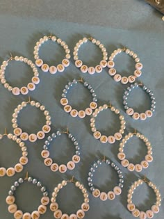 a table topped with lots of different types of bracelets and pearls on top of each other