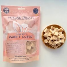 a bag of freeze dried rabbit cubes next to a small bowl of sugary treats