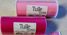 three rolls of pink tulle sitting next to each other on top of a table