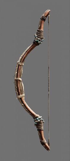 a wooden bow and arrow with rope wrapped around it's ends on a gray background