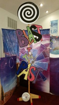 some art work is on display in a room with purple and blue colors, including the word bask