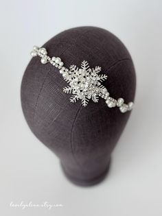 Beautiful snowflake jewel headband made with silver metal, clear rhinestones and white pearls! Snowflake is approximately 1 3/4" and the head piece is approximately 1/2" wide at the widest. Head piece is attached to a 1/8" wide white elastic.  **Please note, pearl placement can be slightly different based on the headband size but overall look will still stay same. ⏰ IN A HURRY? NEED YOUR ORDER FAST? Add the "Rush my Order" listing (click below) in your cart when checking out. By purchasing the " Winder Wonderland, Jewel Headband, Snowflake Headband, Jeweled Headband, Head Piece, Head Accessories, Head Band, Clear Rhinestones, Holiday Christmas