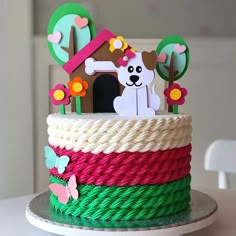 there is a cake that looks like it has a dog in the house on top