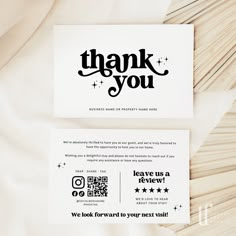 a thank card with the words thank you written in black ink on white paper next to a pile of matches