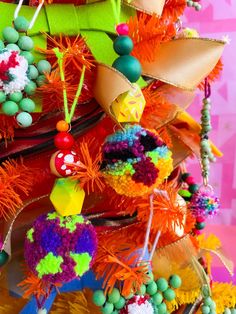 an orange christmas tree decorated with colorful ornaments