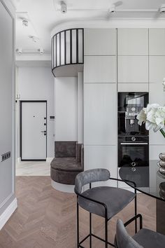 a living room filled with furniture and a spiral staircase