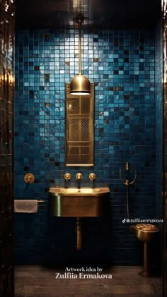 a bathroom with blue tile and gold fixtures