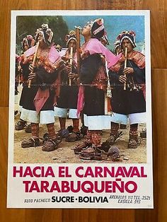 the poster for hacia el carnaval tarabuqueno is displayed on a wooden table