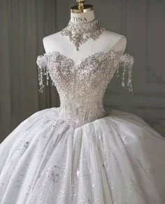 a white wedding dress with silver sequins on it