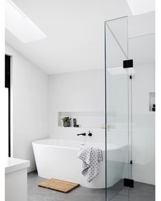 a white bath tub sitting next to a walk in shower