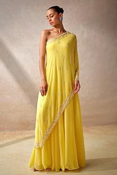 Yellow cape style sleeves one shoulder jumpsuit in georgette base with vine gardenia embellishments using cut dana highlights. - Aza Fashions Indian Readymade Saree, One Sided Sleeve Dress, One Shoulder Haldi Outfit, One Shoulder Suits Indian, Side Open Kurti Designs, One Shoulder Indian Outfits, Stylish Plazo Suits Design, Yellow Dress For Haldi Function, Indo Western Outfits Wedding