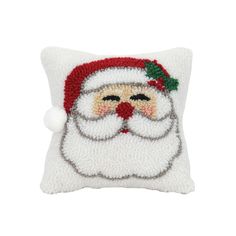 a white pillow with a santa face on it