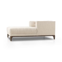 a white couch sitting on top of a wooden frame