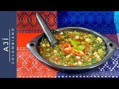 a bowl filled with soup sitting on top of a blue and red table cloth next to a spoon