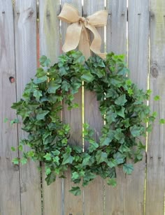 a wreath hanging on the side of a wooden fence