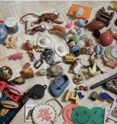 there are many different items on the table together, including buttons and magnets that look like animals