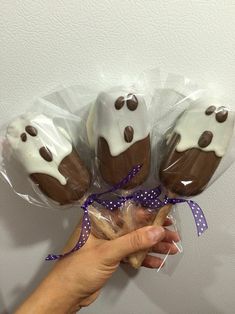 chocolate covered donuts wrapped in cellophane and decorated with white icing