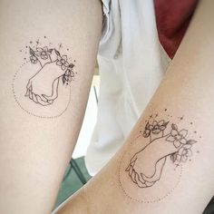 two people with tattoos on their legs, one has a flower and the other has a heart