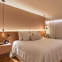 a bedroom with a bed, nightstands and lamps on either side of the bed