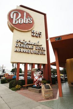 a large sign for a restaurant on the side of a road