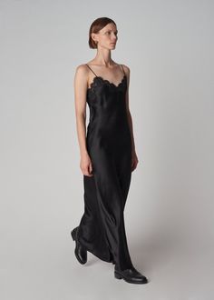 Long slip dress in 16mm opaque biascut silk satin glides gracefully against the skin. French lace trims the neckline. Adjustable spaghetti straps and cleverly positioned encased elasticized back ensure proper fit. French seam, baby hem. Details 100% Silk Trim: 50% Cotton 30% Viscose 20% Polyamide 4704CSSC-CORE Black True to size. See size guide. Approx 47" in total length. Model is 5'9" 30" bust and wears a size Small. Black Velvet Slip Dress, Velvet Slip Dress, Long Slip Dress, Long Slip, Black Slip Dress, Lace Slip Dress, Lace Trims, French Seam, Lace Slip