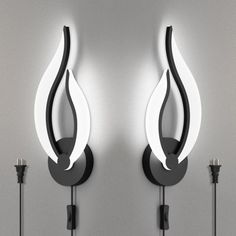 two black and white wall lights next to each other on a gray wall with one light turned off