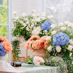 three vases filled with flowers sitting on top of a table