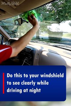 a man cleaning the windshield of his car with a microfibrel cloth on