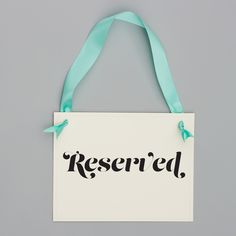 a sign that says reserved hanging on a wall