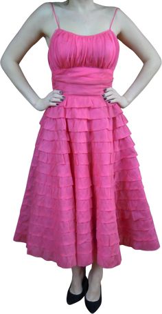 Love Love this DressLayered, Layered SkirtRuched Waist Pleated BodiceLined layer, tulle layer and then full circle skirtSide ZipperThis color is AMAZING, Vibrant, Bright PinkMODEL'S MEASUREMENTS FOR COMPARISON (when we have one) ARE AS FOLLOWS34" BUST ~ 26" WAIST~ 35" HIPS SHE IS 5"6"APPROXIMATE MEASUREMENT GARMENT MEASURED LAYING FLATShoulder: 9"Bust: 16. 5"Waist: 13. 5""Hips: openSleeves: n/aLong: 47. 5" shoulder to hemBased on the chart below I rating this in Excellent Condition skirt Tiny mark on 3rd layer up from the bottom. may lift given a soak, regardless this dress is spectacular Condition Chart Mint: An item is as perfect and pristine as when it was originally made and shows no sign of wear (mint condition is rare for clothing) .Near mint: An item shows only the slightest signs o Fitted A-line Skirt With Ruffles, Spring Dresses With Attached Cancan And Voluminous Skirt, Fitted Dress With Ruffled Full Skirt, Full Petticoat With Ruffles For Party, Fitted Tulle Tiered Skirt Dress, Fitted Tiered Skirt For Prom, Ruffled Flared Skirt Dress, Fitted Tiered Prom Skirt, Fitted Tulle Tiered Dress