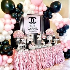 a chanel themed dessert table with black, white and pink balloons