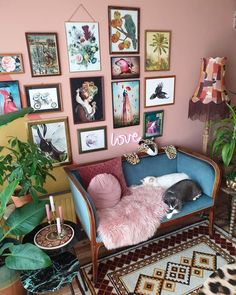 a living room filled with furniture and lots of pictures on the wall above it's couch