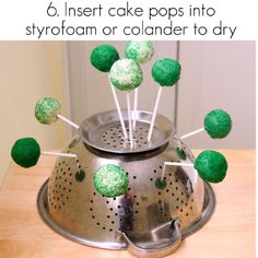 green cake pops in a colander to dry on the stove top with text overlay reading 6 insert cake pops into styrofam or collage to dryer