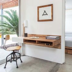 a desk and chair in a room with sliding glass doors