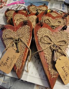 two heart shaped cookies with tags attached to them