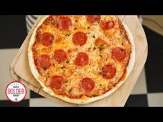 a pepperoni pizza sitting on top of a wooden cutting board