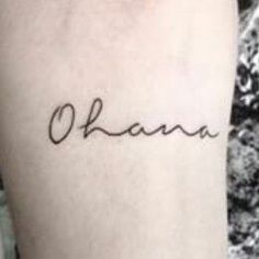 a woman's arm with the word ohana written in cursive font