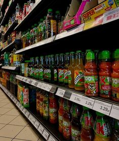 a store shelf filled with lots of different kinds of juice